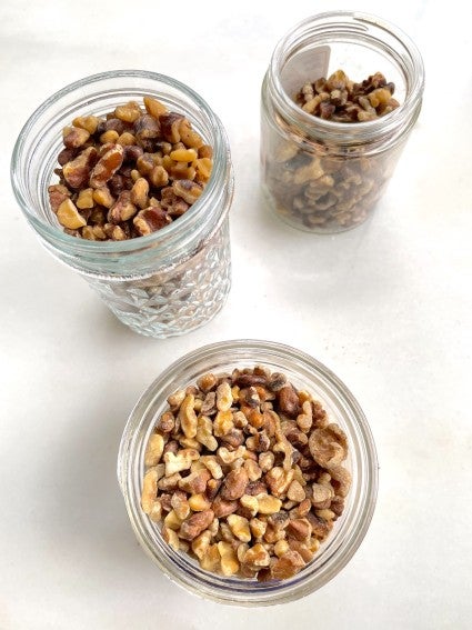 Three jars of toasted walnuts shot from above.